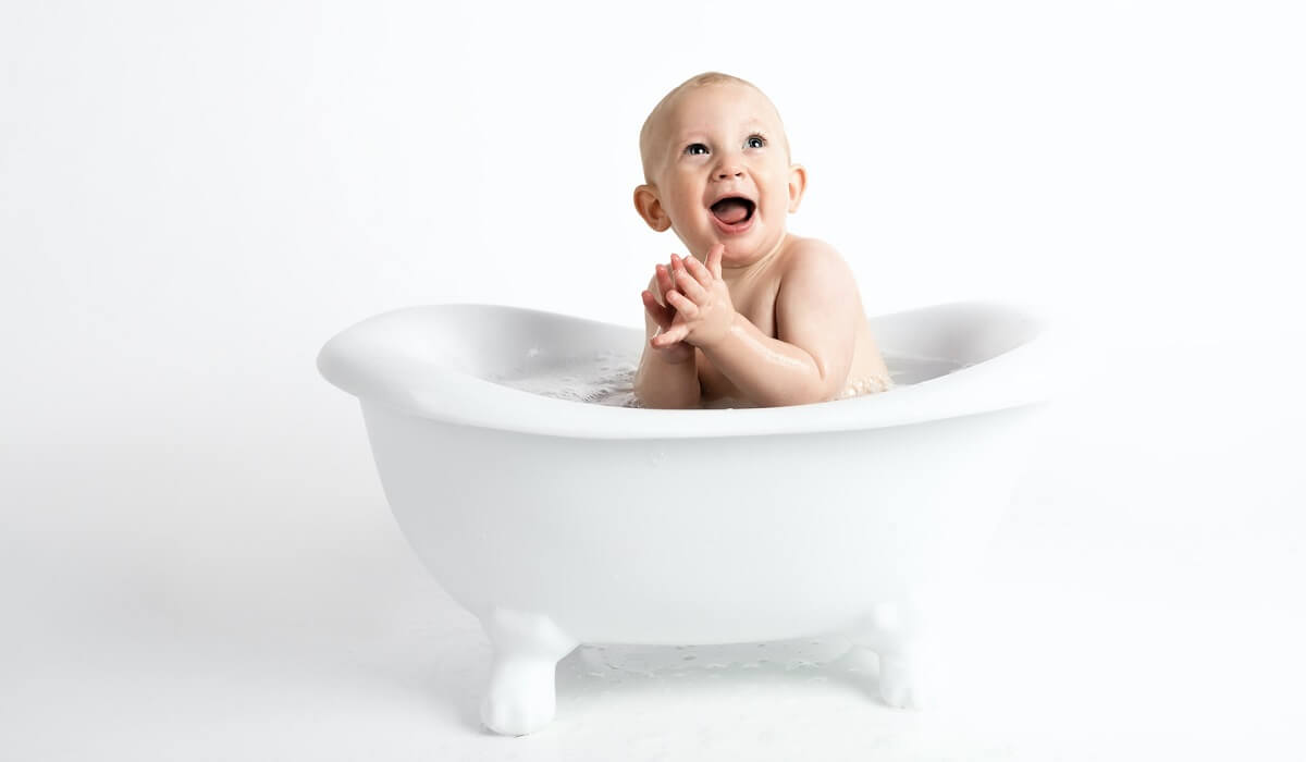 Boy in bathtub bathing