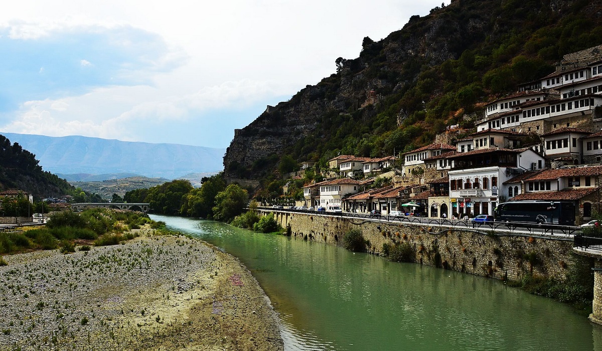 A river running through a lush green valley, Berat, Albania